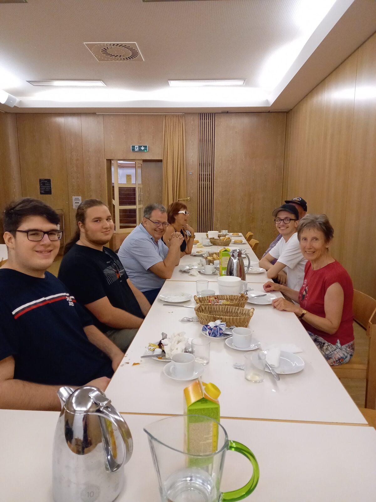 Gruppe beim Frühstückstisch, der sehr bekleckert ist